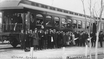 People standing next to train car